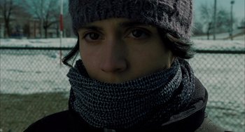 Movie still from “Incendies” (2010), directed by Denis Villeneuve – A woman wearing a hat and a neck warmer; Close Up shot, Low angle