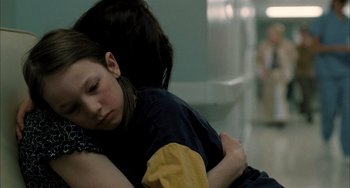 Movie still from “Incendies” (2010), directed by Denis Villeneuve – A young girl is hugging her mother in a hospital room; Close Up shot, Over the shoulder angle