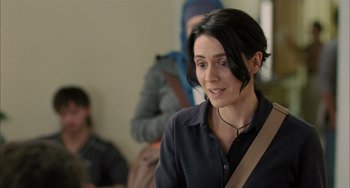 Movie still from “Incendies” (2010), directed by Denis Villeneuve – A woman in a black shirt is looking at the camera; Close Up shot, Over the shoulder angle