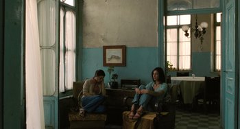 Movie still from “Incendies” (2010), directed by Denis Villeneuve – Two women sitting in chairs in a living room; Wide shot, Low angle