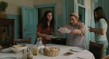 Movie still from “Incendies” (2010), directed by Denis Villeneuve – Two women preparing a meal at a dining table; Medium shot, Over the shoulder angle