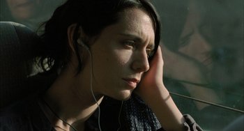 Movie still from “Incendies” (2010), directed by Denis Villeneuve – A young woman with headphones is listening intently to music; Close Up shot, Low angle