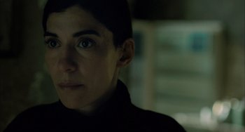 Movie still from “Incendies” (2010), directed by Denis Villeneuve – A person's face in the dark; Close Up shot, Over the shoulder angle