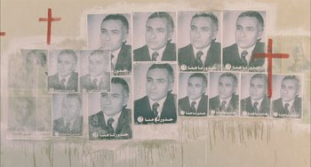 Movie still from “Incendies” (2010), directed by Denis Villeneuve – A bunch of pictures of a man in a business suit; Medium shot, Overhead angle