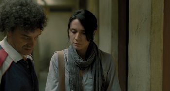 Movie still from “Incendies” (2010), directed by Denis Villeneuve – A woman wearing a scarf standing in front of a wall; Close Up shot, Over the shoulder angle