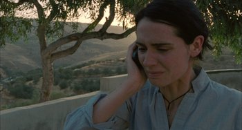 Movie still from “Incendies” (2010), directed by Denis Villeneuve – A woman talking on a cell phone while sitting outside; Close Up shot, High angle