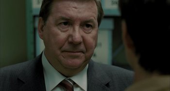 Movie still from “Incendies” (2010), directed by Denis Villeneuve – An older man in a suit and tie looking to his left; Close Up shot, Over the shoulder angle