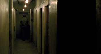 Movie still from “Incendies” (2010), directed by Denis Villeneuve – A couple of doors that are in a room; Wide shot, High angle