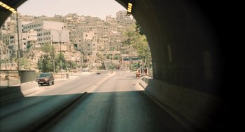 Movie still from “Incendies” (2010), directed by Denis Villeneuve – A view of a city from under a bridge; Extreme Wide shot, High angle