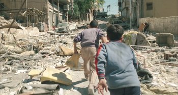 Movie still from “Incendies” (2010), directed by Denis Villeneuve – Two boys are walking through the rubble of a destroyed city; Wide shot, High angle