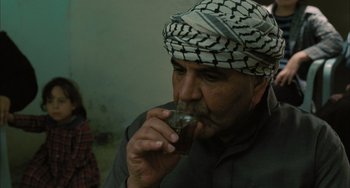 Movie still from “Incendies” (2010), directed by Denis Villeneuve – An old man drinking a cup of coffee; Medium shot, Over the shoulder angle