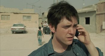 Movie still from “Incendies” (2010), directed by Denis Villeneuve – A man on a cell phone in the middle of the street; Close Up shot, High angle