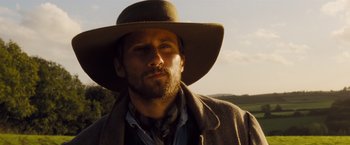 Movie still from “Far from the Madding Crowd” (2015), directed by Thomas Vinterberg – A man with a beard wearing a cowboy hat; Close Up shot, Low angle