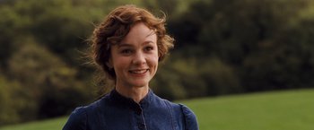Movie still from “Far from the Madding Crowd” (2015), directed by Thomas Vinterberg – A woman with red curly hair smiling for the camera; Close Up shot, Low angle
