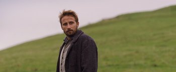 Movie still from “Far from the Madding Crowd” (2015), directed by Thomas Vinterberg – A man standing in a field with a beard; Close Up shot, Low angle