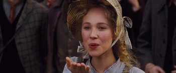 Movie still from “Far from the Madding Crowd” (2015), directed by Thomas Vinterberg – A woman in a hat is holding her hand up to her mouth; Close Up shot, Low angle