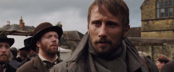 Movie still from “Far from the Madding Crowd” (2015), directed by Thomas Vinterberg – Two men standing next to each other on a cloudy day; Close Up shot, Over the shoulder angle