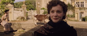 Movie still from “Far from the Madding Crowd” (2015), directed by Thomas Vinterberg – A woman standing in front of a brown cow; Close Up shot, Over the shoulder angle