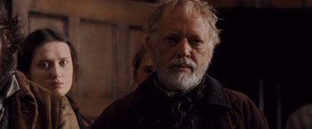 Movie still from “Far from the Madding Crowd” (2015), directed by Thomas Vinterberg – An older man with a beard and a mustache; Close Up shot, Low angle
