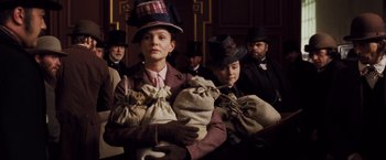 Movie still from “Far from the Madding Crowd” (2015), directed by Thomas Vinterberg – A group of people wearing hats and carrying bags; Medium shot, Low angle