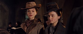 Movie still from “Far from the Madding Crowd” (2015), directed by Thomas Vinterberg – Two women dressed up in vintage clothing and hats; Close Up shot, Low angle
