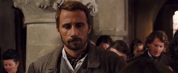 Movie still from “Far from the Madding Crowd” (2015), directed by Thomas Vinterberg – A person with a beard and mustache; Close Up shot, Over the shoulder angle