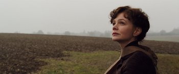 Movie still from “Far from the Madding Crowd” (2015), directed by Thomas Vinterberg – A woman standing in the middle of an empty field; Close Up shot, Low angle