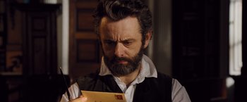 Movie still from “Far from the Madding Crowd” (2015), directed by Thomas Vinterberg – A man holding an envelope in his hands; Close Up shot, Over the shoulder angle