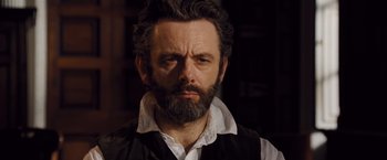 Movie still from “Far from the Madding Crowd” (2015), directed by Thomas Vinterberg – A man with a beard is looking at the camera; Close Up shot, Over the shoulder angle