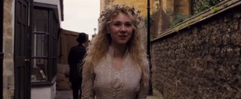 Movie still from “Far from the Madding Crowd” (2015), directed by Thomas Vinterberg – A woman with long blonde curly hair wearing a flower crown; Close Up shot, Over the shoulder angle