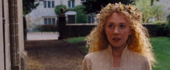 Movie still from “Far from the Madding Crowd” (2015), directed by Thomas Vinterberg – A woman with a flower wreath on her head; Close Up shot, Over the shoulder angle