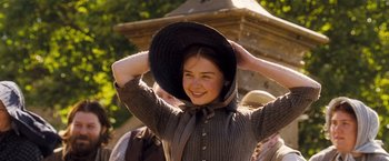 Movie still from “Far from the Madding Crowd” (2015), directed by Thomas Vinterberg – A young woman wearing a black hat and a brown dress; Medium shot, Low angle