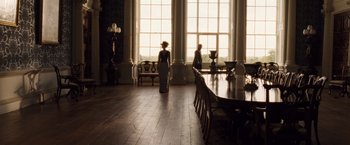 Movie still from “Far from the Madding Crowd” (2015), directed by Thomas Vinterberg – Two people standing in front of large windows in a room; Wide shot, Over the shoulder angle