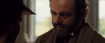 Movie still from “Far from the Madding Crowd” (2015), directed by Thomas Vinterberg – A person wearing a suit and tie; Close Up shot, Over the shoulder angle