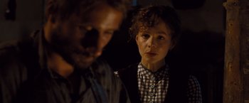 Movie still from “Far from the Madding Crowd” (2015), directed by Thomas Vinterberg – A man and a woman standing next to each other in the dark; Close Up shot, Over the shoulder angle