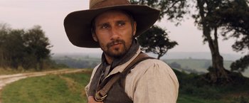 Movie still from “Far from the Madding Crowd” (2015), directed by Thomas Vinterberg – A person wearing a hat; Close Up shot, Low angle