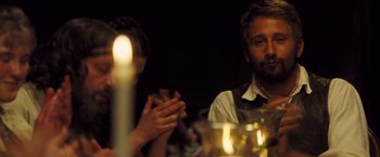 Movie still from “Far from the Madding Crowd” (2015), directed by Thomas Vinterberg – A man sitting at a table with a candle in front of him; Close Up shot, Over the shoulder angle
