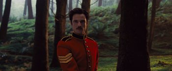 Movie still from “Far from the Madding Crowd” (2015), directed by Thomas Vinterberg – A man in a red and black uniform standing in a forest; Close Up shot, Low angle