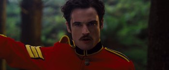 Movie still from “Far from the Madding Crowd” (2015), directed by Thomas Vinterberg – A person wearing a red and yellow uniform; Close Up shot, Low angle