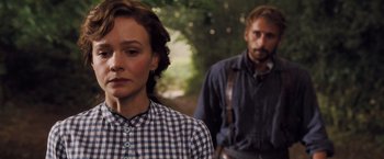 Movie still from “Far from the Madding Crowd” (2015), directed by Thomas Vinterberg – A man and a woman standing next to each other in front of trees; Close Up shot, Over the shoulder angle