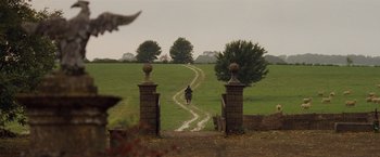 Movie still from “Far from the Madding Crowd” (2015), directed by Thomas Vinterberg – A person riding a horse down a path through a field; Extreme Wide shot, High angle