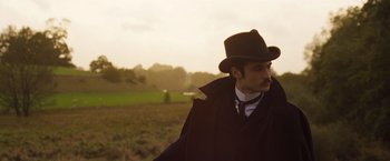 Movie still from “Far from the Madding Crowd” (2015), directed by Thomas Vinterberg – A man wearing a hat standing in a field; Medium shot, Low angle
