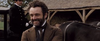 Movie still from “Far from the Madding Crowd” (2015), directed by Thomas Vinterberg – A person wearing a suit and tie; Close Up shot, Over the shoulder angle
