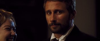 Movie still from “Far from the Madding Crowd” (2015), directed by Thomas Vinterberg – A person wearing a suit and tie; Close Up shot, Over the shoulder angle