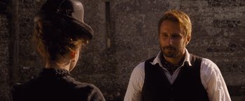 Movie still from “Far from the Madding Crowd” (2015), directed by Thomas Vinterberg – A man and a woman standing next to each other in front of a stone wall; Close Up shot, Over the shoulder angle