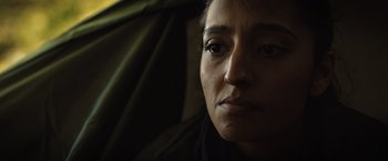 Movie still from “In the Earth” (2021), directed by Ben Wheatley – A woman's face in the dark; Close Up shot, Low angle
