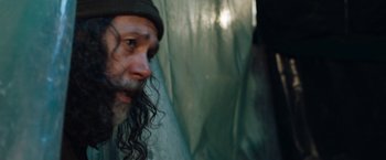 Movie still from “In the Earth” (2021), directed by Ben Wheatley – A person with long hair; Close Up shot, Over the shoulder angle