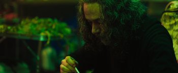 Movie still from “In the Earth” (2021), directed by Ben Wheatley – A man with long curly hair is holding a toothbrush; Close Up shot, Low angle