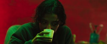 Movie still from “In the Earth” (2021), directed by Ben Wheatley – A woman is drinking a cup of coffee; Close Up shot, High angle