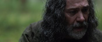 Movie still from “In the Earth” (2021), directed by Ben Wheatley – A person with long hair; Close Up shot, Over the shoulder angle